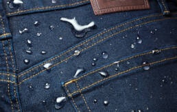 Marks & Spencer technical denim macro shot with water drops