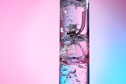 Victoria's Secret Bombshell Parfum editorial water splash shot with multi-coloured background