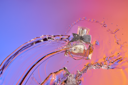 Miss Dior Eau De Parfum editorial water splash shot with multi-coloured background